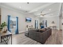 Open living room with gray sofa, recessed lighting, a ceiling fan, and stylish gray flooring at 906 Sims Sw St, Atlanta, GA 30310