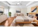 Bright bedroom featuring hardwood floors, modern decor and large window at 1832 Glenwood Ln, Snellville, GA 30078