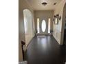 Inviting foyer featuring dark hardwood floors and an arched doorway adding architectural interest at 4371 Minkslide Sw Dr, South Fulton, GA 30331