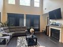 Spacious living room with a fireplace, high ceilings and large windows allowing natural light at 4371 Minkslide Sw Dr, South Fulton, GA 30331