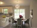 The dining area features a modern light fixture and a view of the backyard at 5017 Galbraith Cir, Stone Mountain, GA 30088