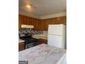Traditional kitchen equipped with oak cabinets, white countertops, and modern appliances at 5626 Pine Gate Pine Gate Dr, Riverdale, GA 30349