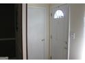Bright entryway with a white front door with a decorative window and a coat closet at 6064 Monica Dr, Morrow, GA 30260