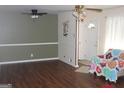 Cozy living room with wood floors, neutral walls, and a decorative ceiling fan at 6064 Monica Dr, Morrow, GA 30260