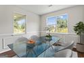 Bright dining room with large windows and a modern glass table at 217 Crystal Ct, Hampton, GA 30228