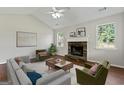 Cozy living room with stone fireplace, vaulted ceiling, and ample natural light at 217 Crystal Ct, Hampton, GA 30228