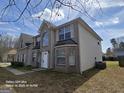 Two-story home featuring brick and vinyl siding, complemented by an arched window and well-kept lawn at 115 Portland Pl, Jonesboro, GA 30238