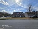 Suburban two-story home boasting an arched entryway window and a well maintained lawn on a sunny day at 115 Portland Pl, Jonesboro, GA 30238