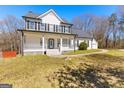 Beautiful two-story home featuring a classic design, black shutters, and inviting front porch at 821 Hood Rd, Fayetteville, GA 30214
