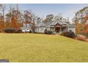 Inviting single-Gathering home with an expansive front lawn, well-maintained landscaping, and a quaint entryway at 1080 Gaithers Rd, Mansfield, GA 30055