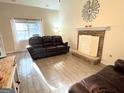 Bright living room with a stone fireplace and wood style flooring at 142 Kylee Ct, Villa Rica, GA 30180