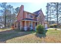 Attractive two-story home with a charming front porch and lush, green lawn at 110 Paces Dr, Fayetteville, GA 30215
