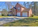 Beautiful home with two-car garage, stone facade, and covered porch with inviting curb appeal at 110 Paces Dr, Fayetteville, GA 30215