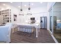 Bright, open kitchen featuring stainless steel appliances, large island with seating, and a sliding glass door to the outside at 170 Fowler St # 200, Woodstock, GA 30188