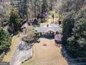 Ranch-style home features mature trees, large lawn, and covered front porch at 2218 Young Rd, Stone Mountain, GA 30088