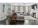 Spacious living room features a cozy fireplace, large sectional, and dark hardwood flooring at 5135 Arnold St, Covington, GA 30014