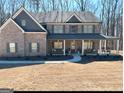 Attractive two-story home with a long covered porch, perfect for enjoying the outdoors at 830 Turner Rd, Mcdonough, GA 30252