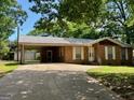 Charming brick home featuring a carport, tidy landscaping, and a driveway offering ample parking at 360 Meadowbrook Dr, Mcdonough, GA 30253