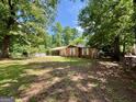 Inviting single-Gathering home with lush greenery and mature trees surrounding the property at 360 Meadowbrook Dr, Mcdonough, GA 30253