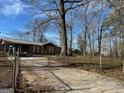 Ranch style home with metal roof, fenced yard and a long driveway at 360 Meadowbrook Dr, Mcdonough, GA 30253