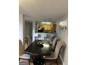 A dining room with wood floors and modern decor opens to the kitchen at 45 Fieldview Ln, Covington, GA 30016