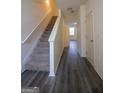 Inviting entryway featuring durable gray flooring, a staircase, and a bright, open doorway at 6342 Kinsland Ct, Lithonia, GA 30058