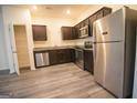 Modern kitchen features stainless steel appliances, granite countertops and hardwood flooring at 6342 Kinsland Ct, Lithonia, GA 30058