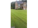 Beautifully manicured lawn leading to a traditional two-story home with a well-maintained exterior at 2441 Noelle Ln, Powder Springs, GA 30127