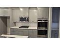 Modern kitchen features stainless steel appliances and shaker style cabinetry at 336 Traditions Ln # 147, Hampton, GA 30228