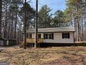 Well maintained home with traditional siding, inviting porch with new steps surrounded by a lush wooded landscape at 2211 Newborn Rd, Rutledge, GA 30663