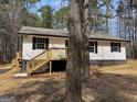 Well-maintained home featuring traditional siding, and inviting front porch with new steps, set in a peaceful wooded area at 2211 Newborn Rd, Rutledge, GA 30663