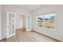 Cozy room with glass panel french doors and a large window with a view of the yard at 3725 Heron Creek Ct, Loganville, GA 30052
