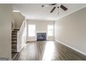 Bright living room featuring a fireplace, wood floors, and a staircase leading to the upper level at 5105 Cascade Hills Cir, Atlanta, GA 30331