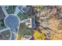 Aerial view of home in a cul-de-sac, showcasing the roof, yard and surrounding neighborhood at 5997 Wildcreek Rd, Sugar Hill, GA 30518