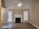 Spacious living room with wood floors, a fireplace, and a ceiling fan at 1335 Sweetwater Blf, Snellville, GA 30039