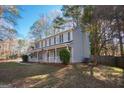 Traditional home featuring a covered porch, blue shutters, and a manicured lawn at 403 Sandown Dr, Peachtree City, GA 30269