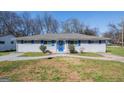 Charming single-story home with blue shutters and a walkway leading to the front door at 1393 Vesta Ave, Atlanta, GA 30344
