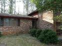 Brick home with an attached garage, shuttered windows, and mature landscaping at 3045 Weslock Cir, Decatur, GA 30034