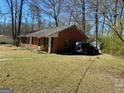 Image shows the front of the brick home, offering a glimpse of the property's exterior at 924 Polk Rd, Moreland, GA 30259