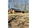 Distant view of the brick home with a spacious lawn at 924 Polk Rd, Moreland, GA 30259