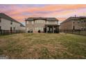 Spacious backyard features a covered patio and full fence, perfect for outdoor gatherings at 3225 Alhambra Cir, Hampton, GA 30228