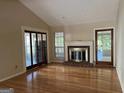 Open living room features a cozy fireplace, hardwood floors, and natural light at 4889 Wedgewood Way, Stone Mountain, GA 30088