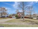 Wide shot of a two-story home with a long driveway and lush green lawn at 912 Shadow Ridge Cir, Stockbridge, GA 30281