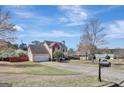 Suburban home featuring an attached garage, manicured lawn and mature trees at 912 Shadow Ridge Cir, Stockbridge, GA 30281