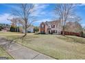 Residential home with well-maintained front lawn and mature trees along the street at 912 Shadow Ridge Cir, Stockbridge, GA 30281