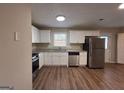 Modern kitchen featuring stainless steel appliances, white cabinets, and a granite countertop at 2987 Landmark Se Dr, Conyers, GA 30094