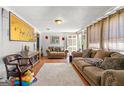 Inviting living room featuring neutral decor, wood flooring, and ample seating at 1055 Adrian Sw Cir, Conyers, GA 30094