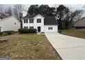 Charming two-story white home with manicured lawn, dark shutters, and an attached garage at 2795 Oxford Dr, Decatur, GA 30034