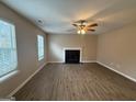 Bright living room featuring hardwood floors, fireplace, and large windows letting in natural light at 2795 Oxford Dr, Decatur, GA 30034