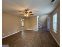 Spacious living area with hardwood floors, ceiling fan, and staircase leading to the upper level at 2795 Oxford Dr, Decatur, GA 30034